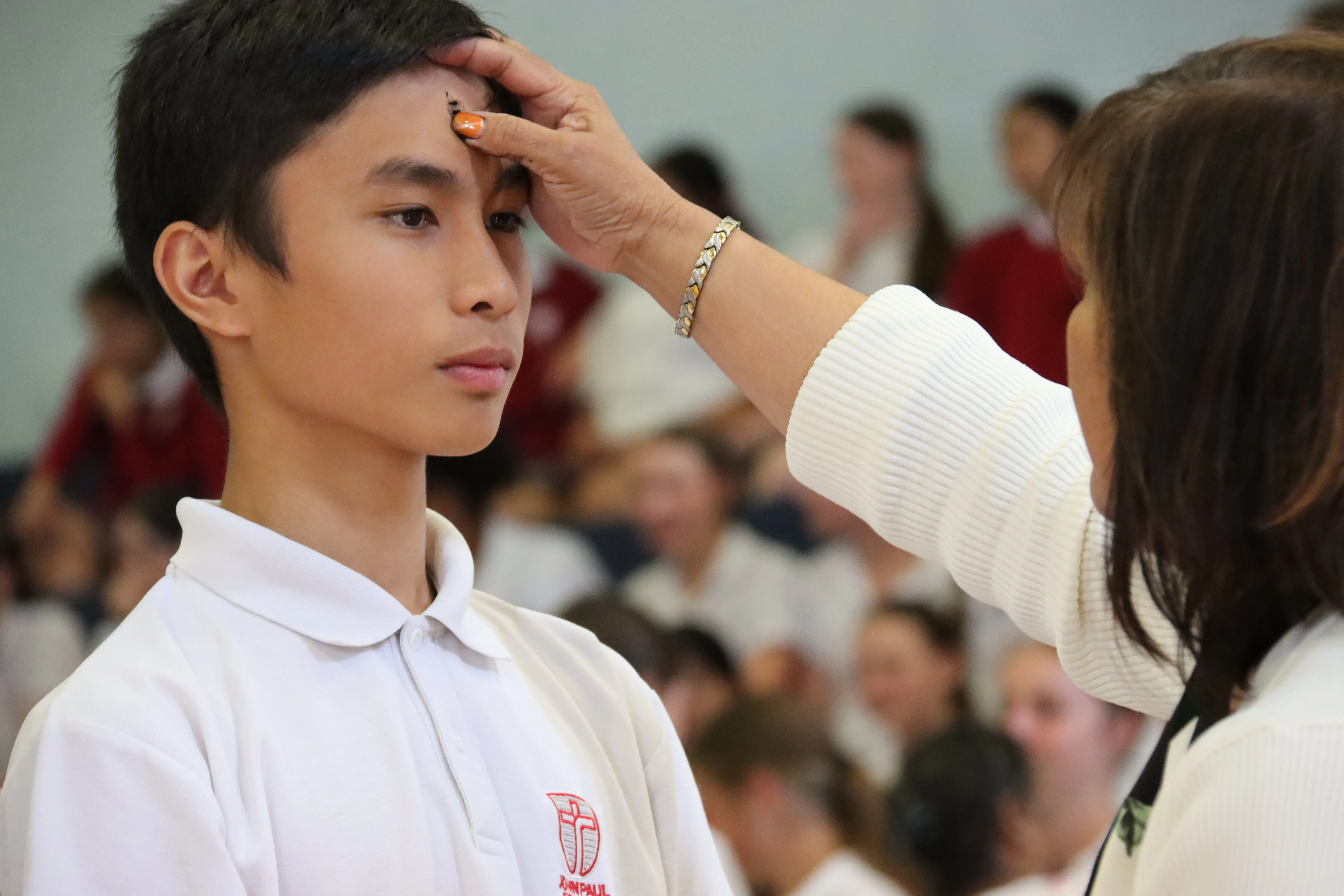 Another image of a boy getting ashes on his forehead