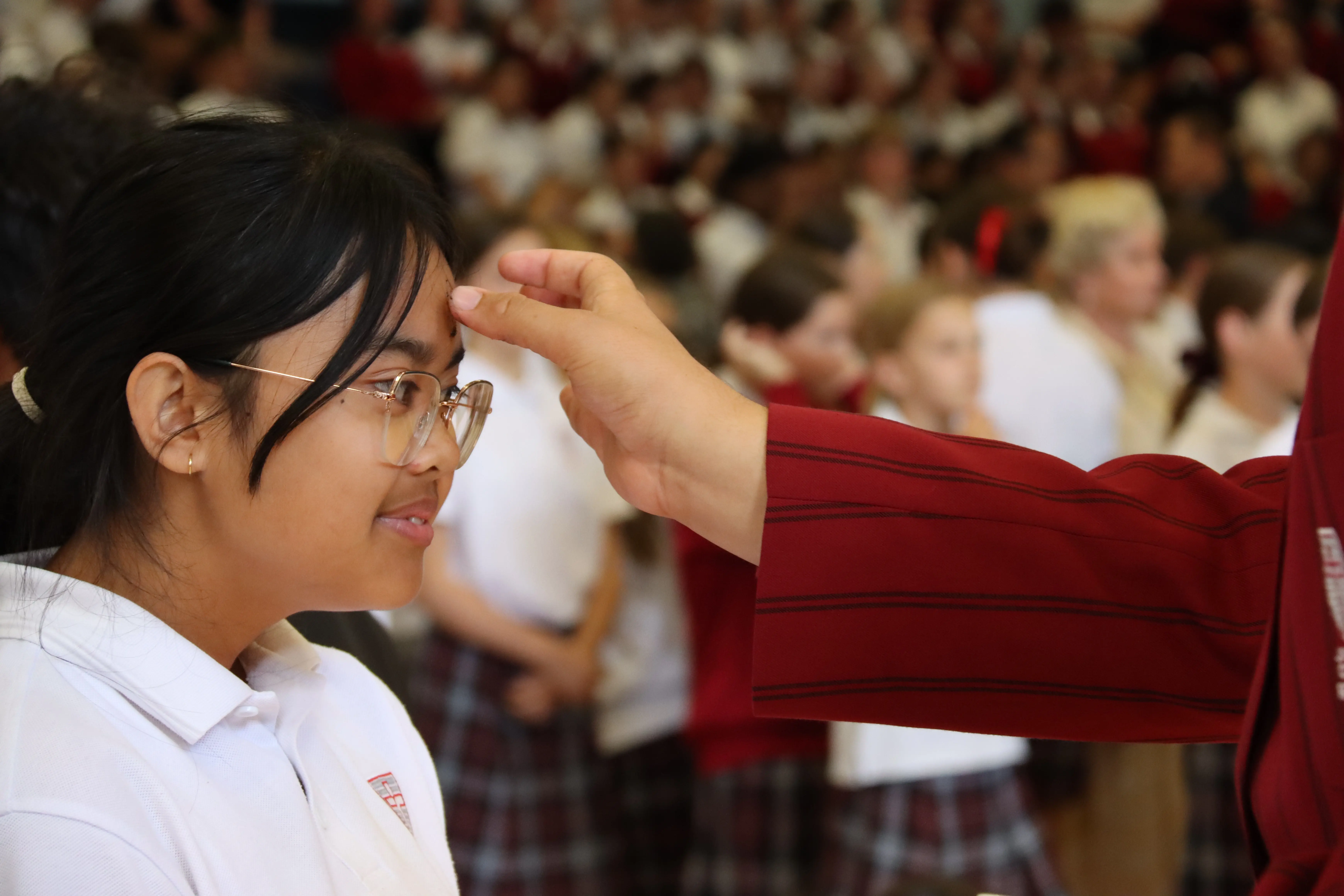 Image of A girl getting ash on her forehead