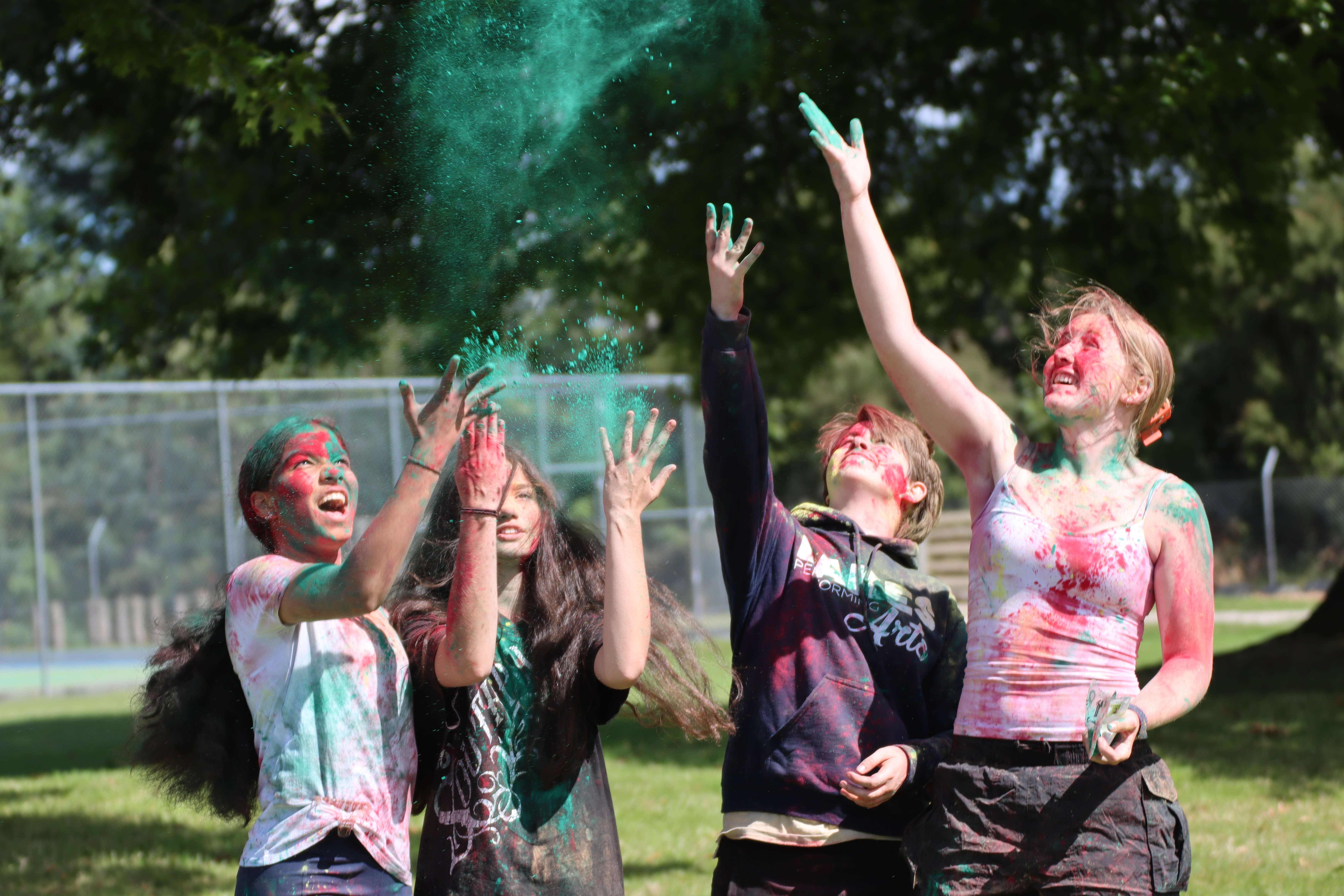 Image of people celebrating Holi Fest with colourful powder explosions