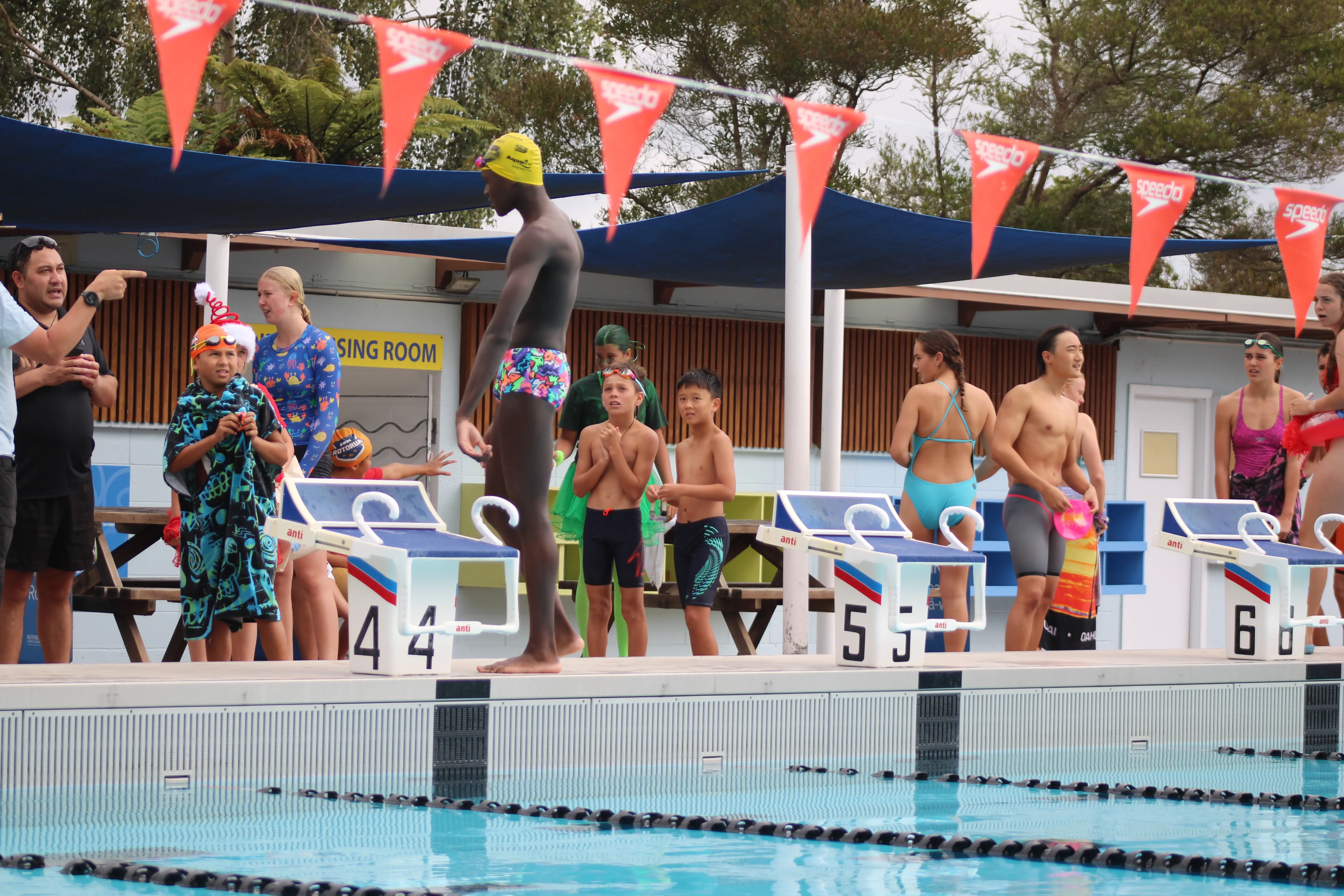 Image of people waiting by the pool