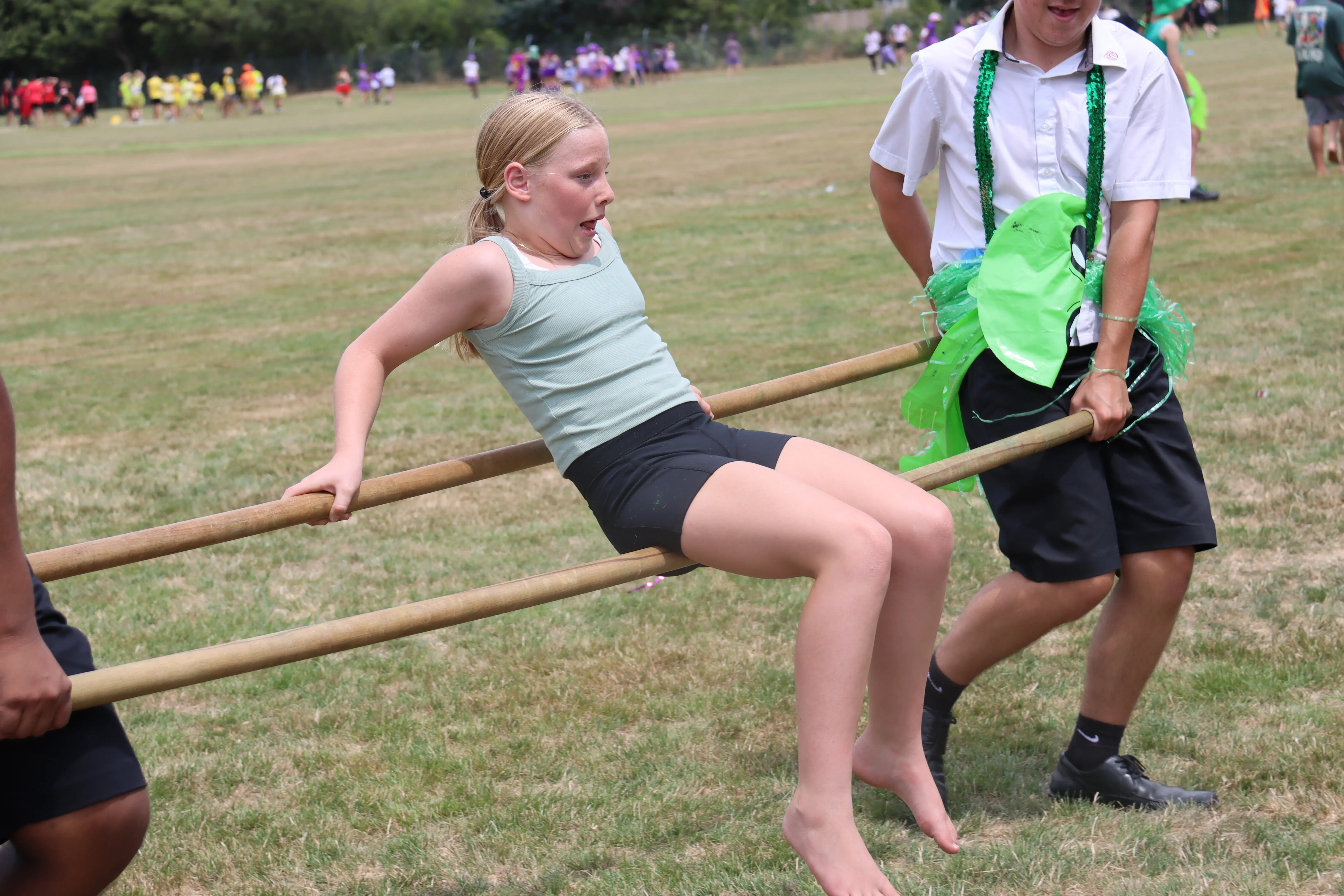 Image of a girl getting carried by sticks