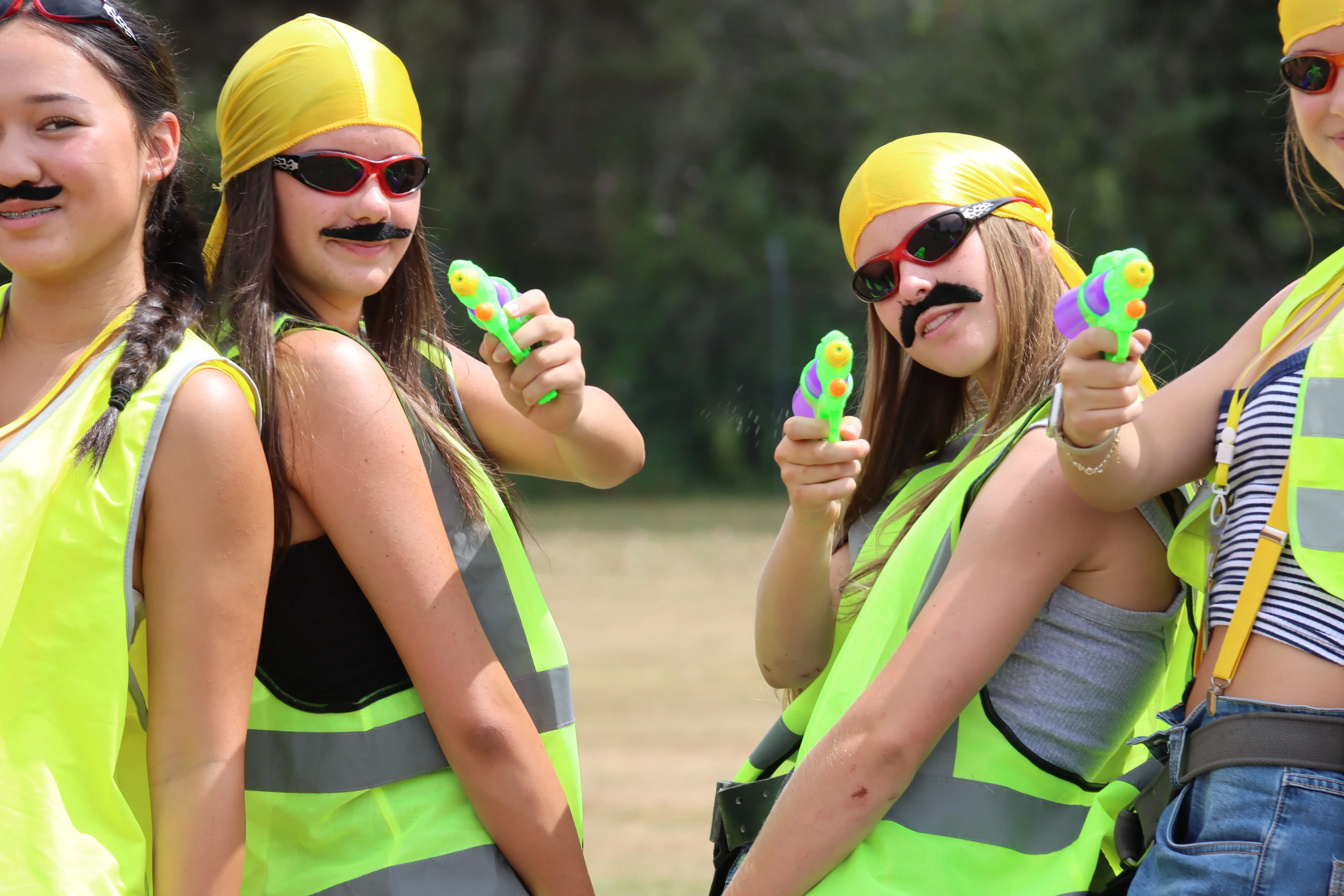 Image of girls dressed in yellow looking at the camera